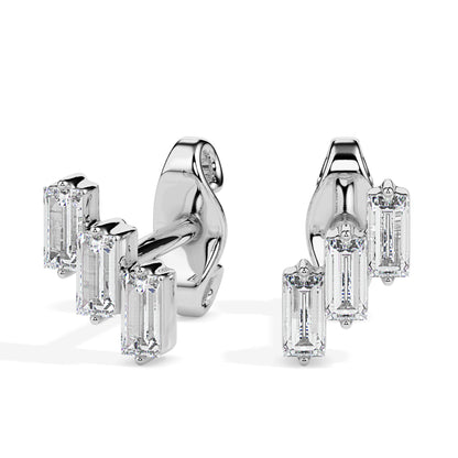 Pair of gold diamond earrings on a white background