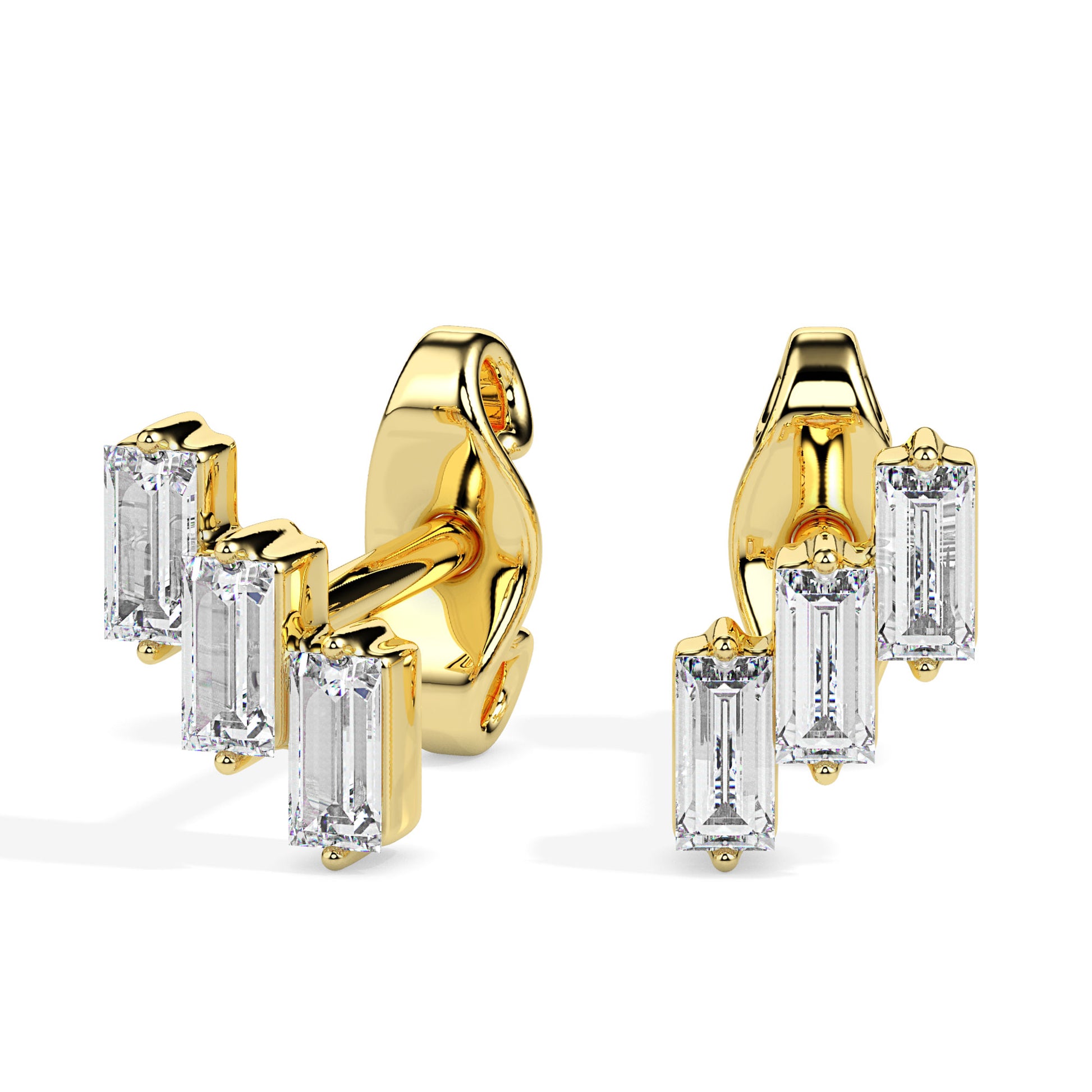 Gold earrings with baguette cut diamonds on a white background.