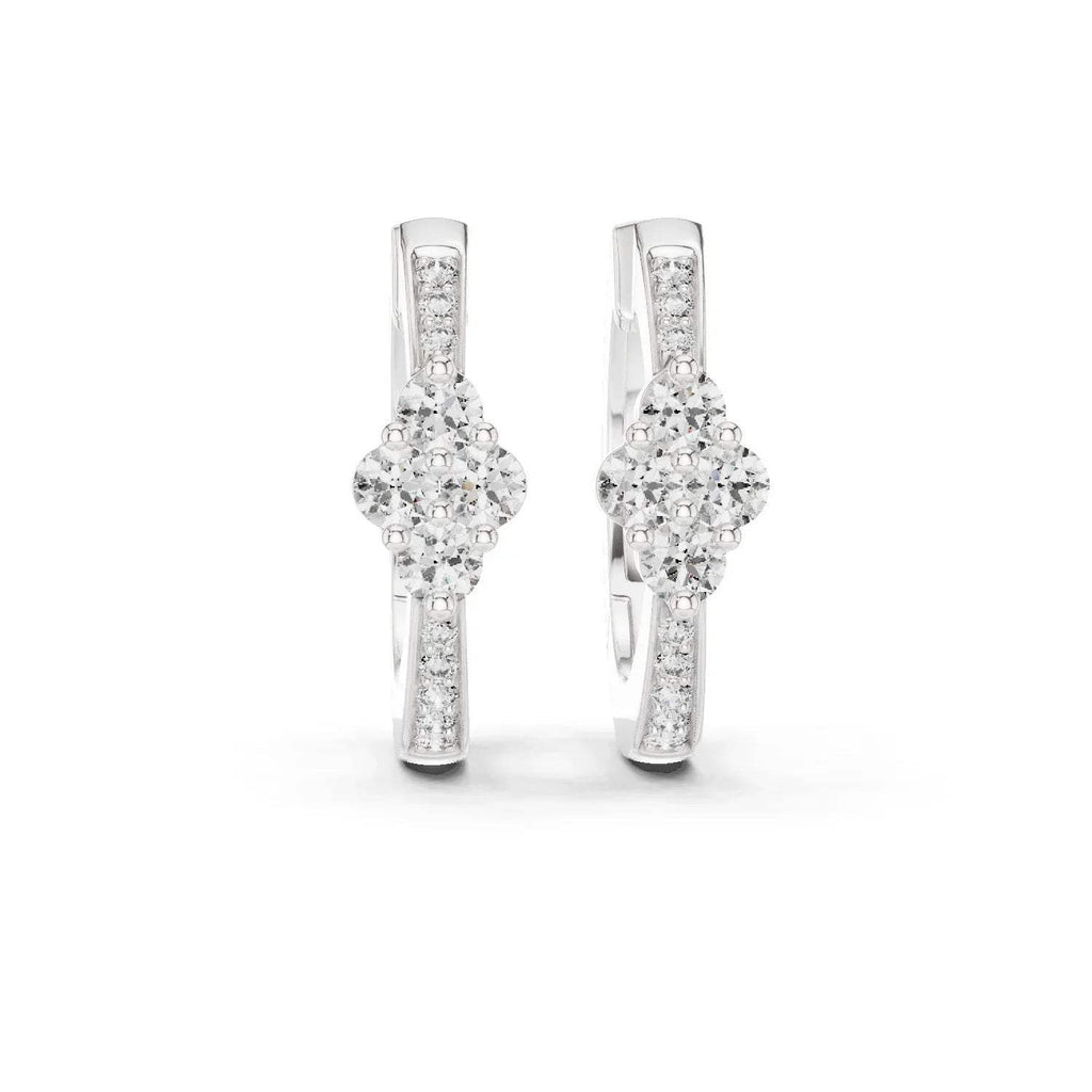 Pair of white gold & real diamond earrings on a white background