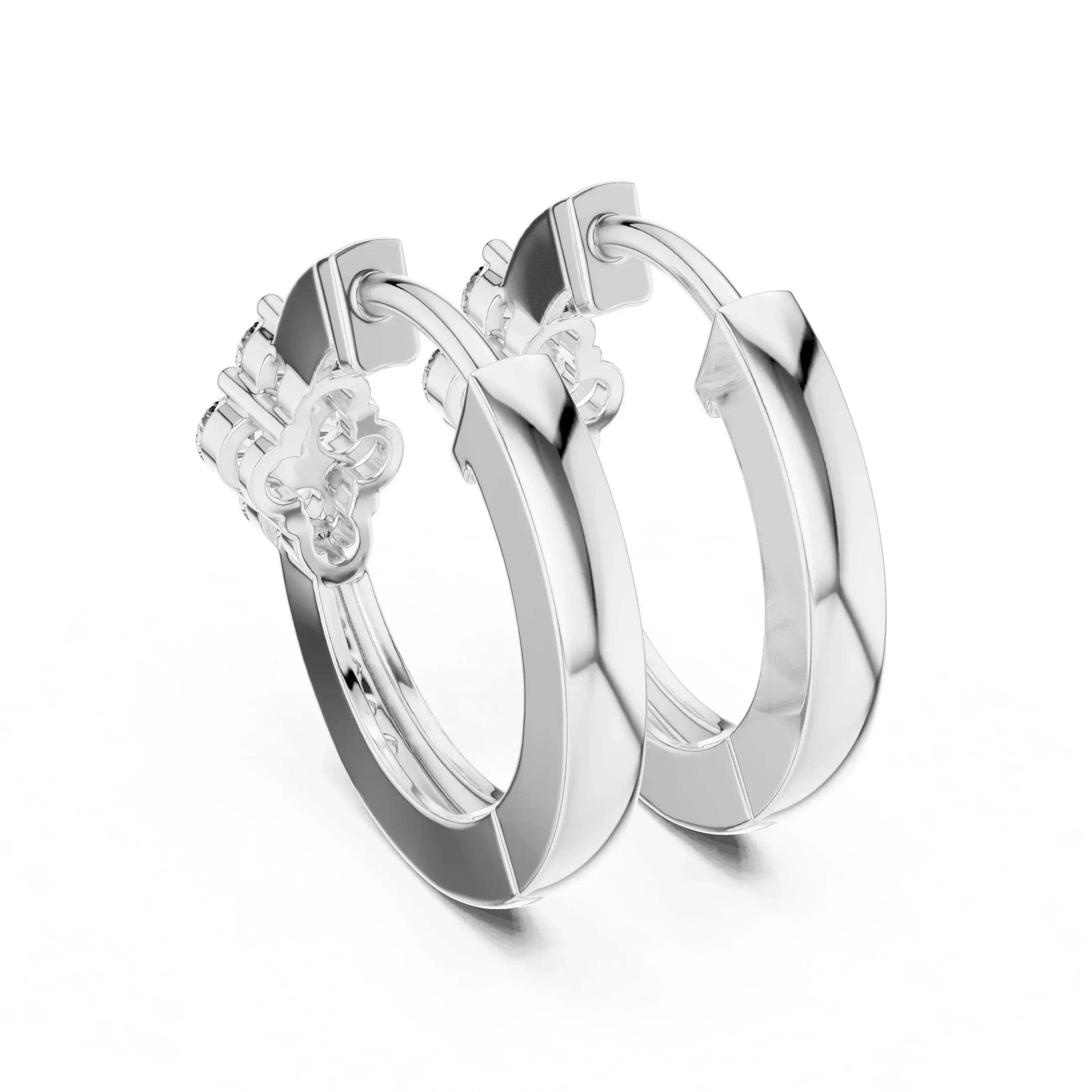 Pair of white gold & real diamond hoop earrings on a white background
