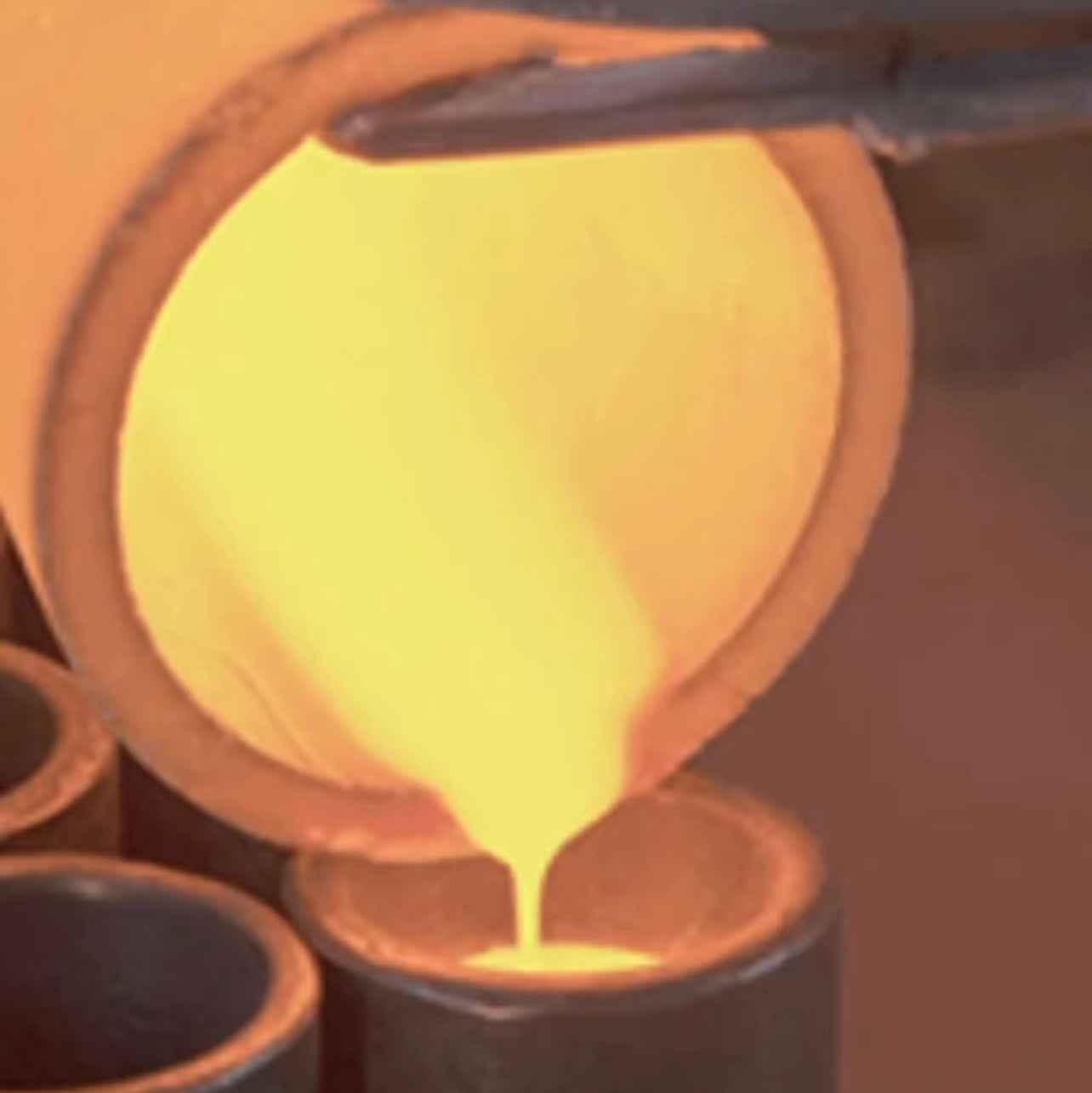 Molten metal being poured into a mold