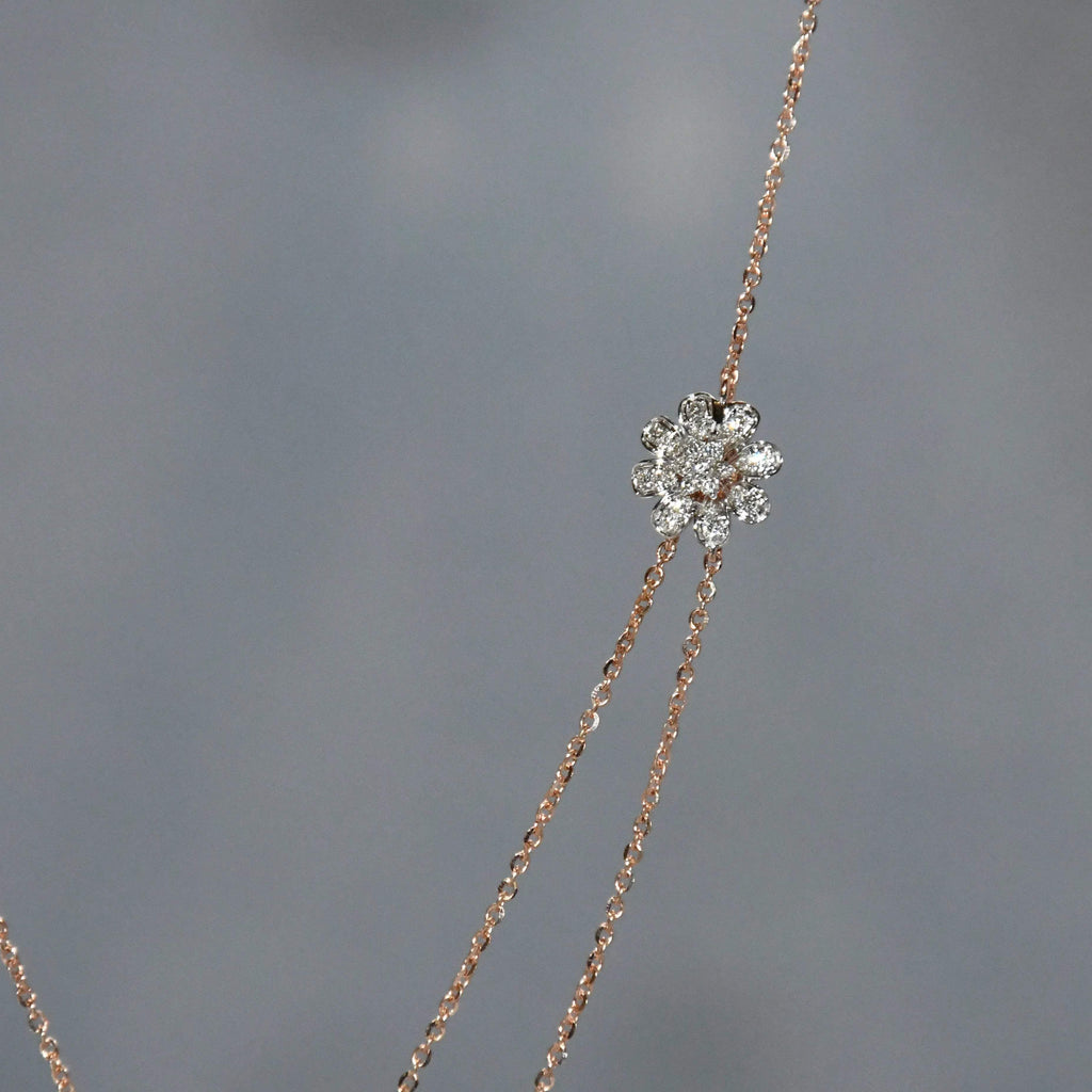 Delicate necklace with a diamond pendant on a gray background