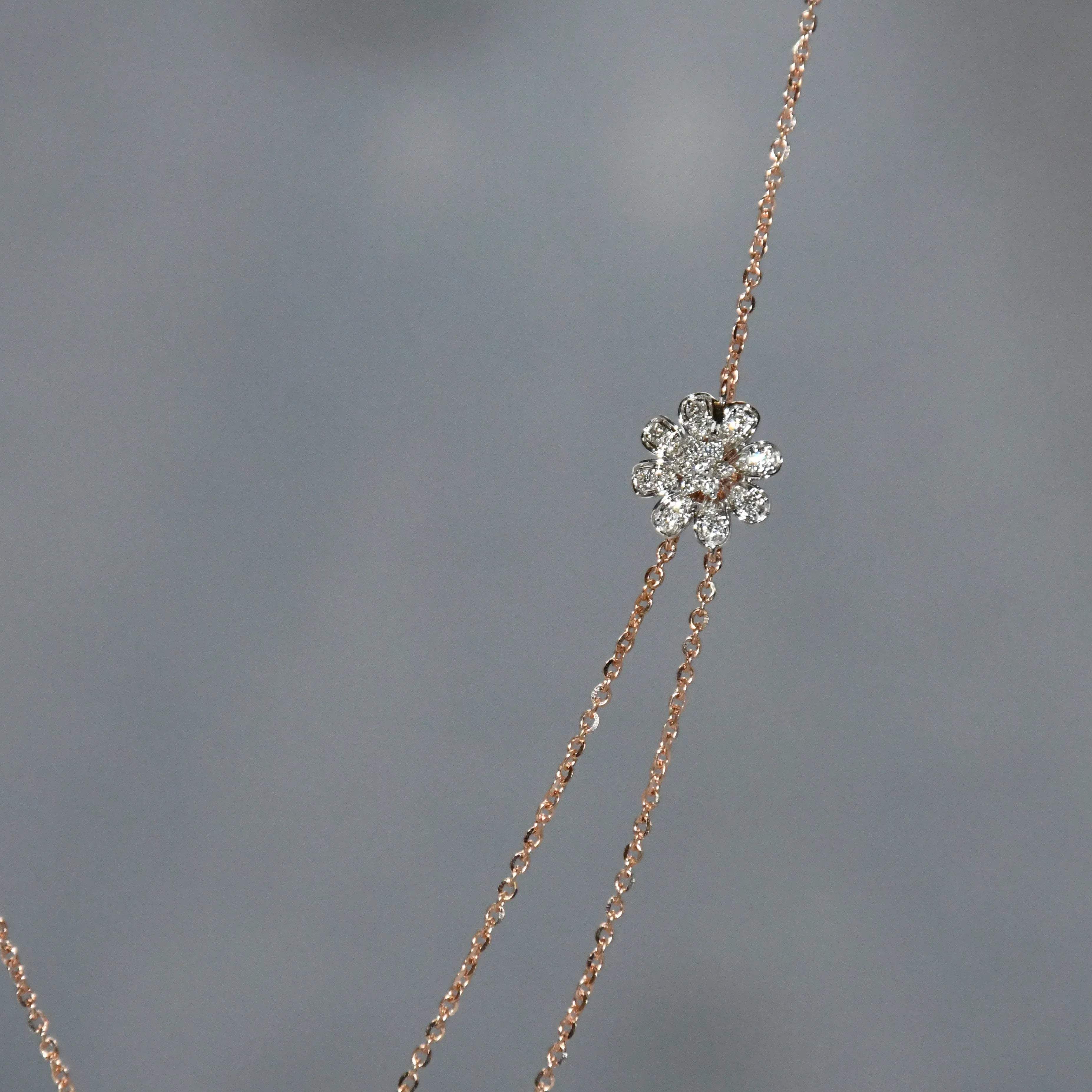 Delicate necklace with a diamond pendant on a gray background