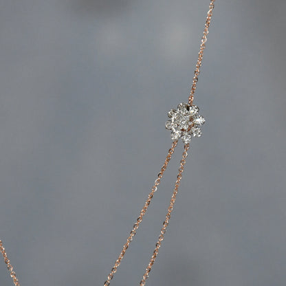 Delicate necklace with a diamond pendant on a gray background