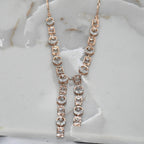 Rose gold necklace with diamonds on a marble surface