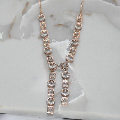 Rose gold necklace with diamonds on a marble surface