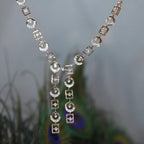 Delicate diamond necklace on a blurred natural background