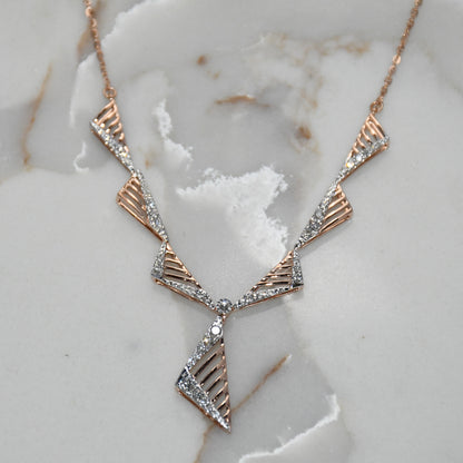gold and diamond necklace on a marble surface