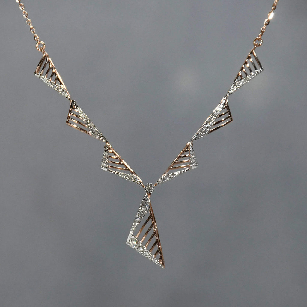Geometric diamond necklace with triangular design on a gray background.