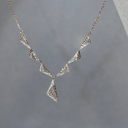 Diamond necklace on a gray background.