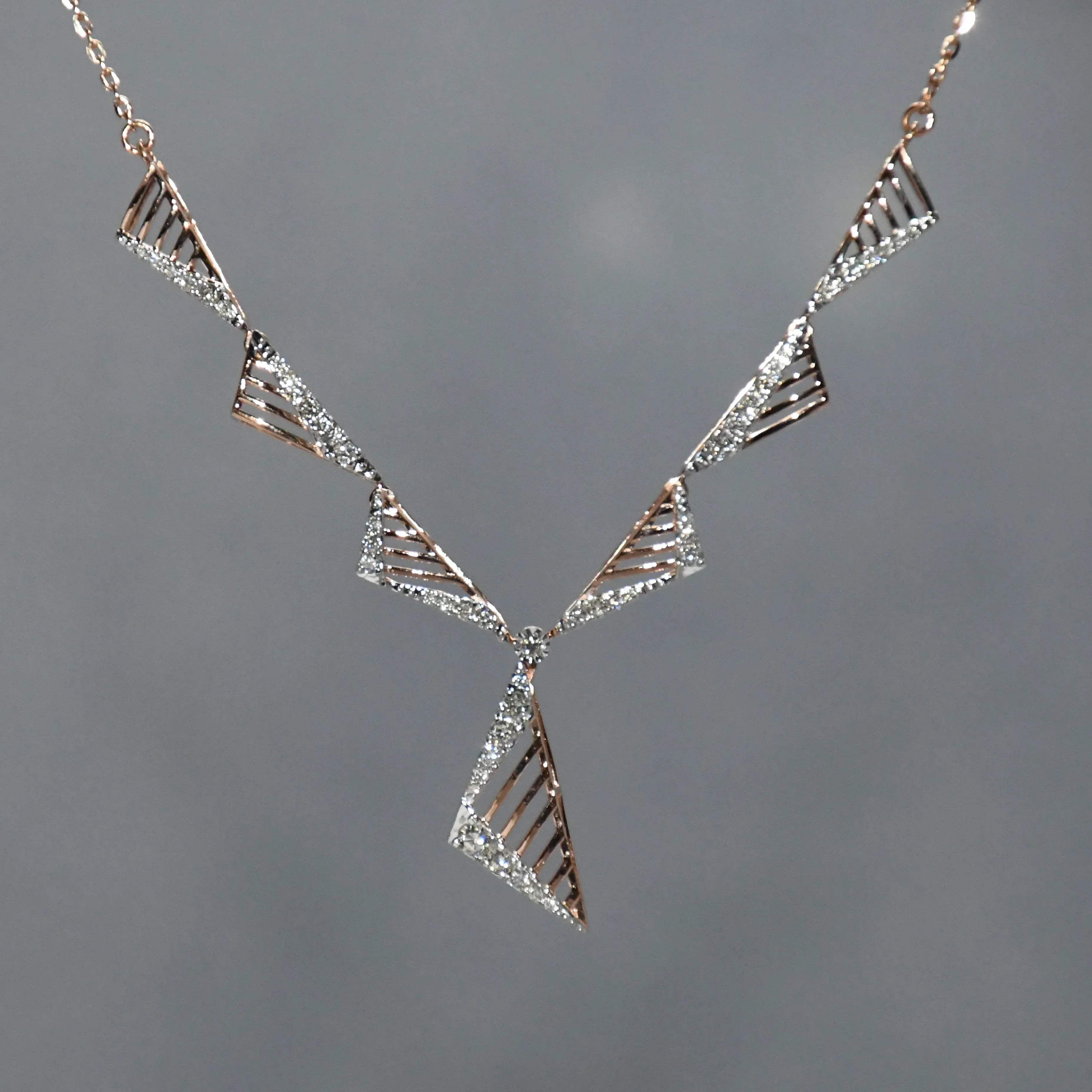 diamond necklace with geometric design on a gray background