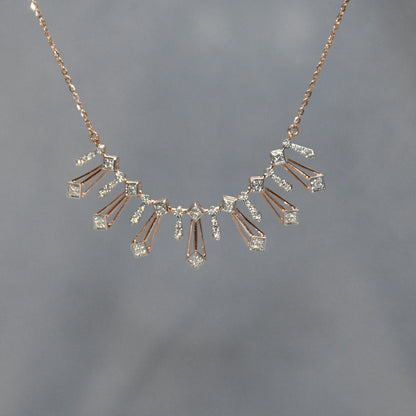 Gold necklace with diamonds on a gray background