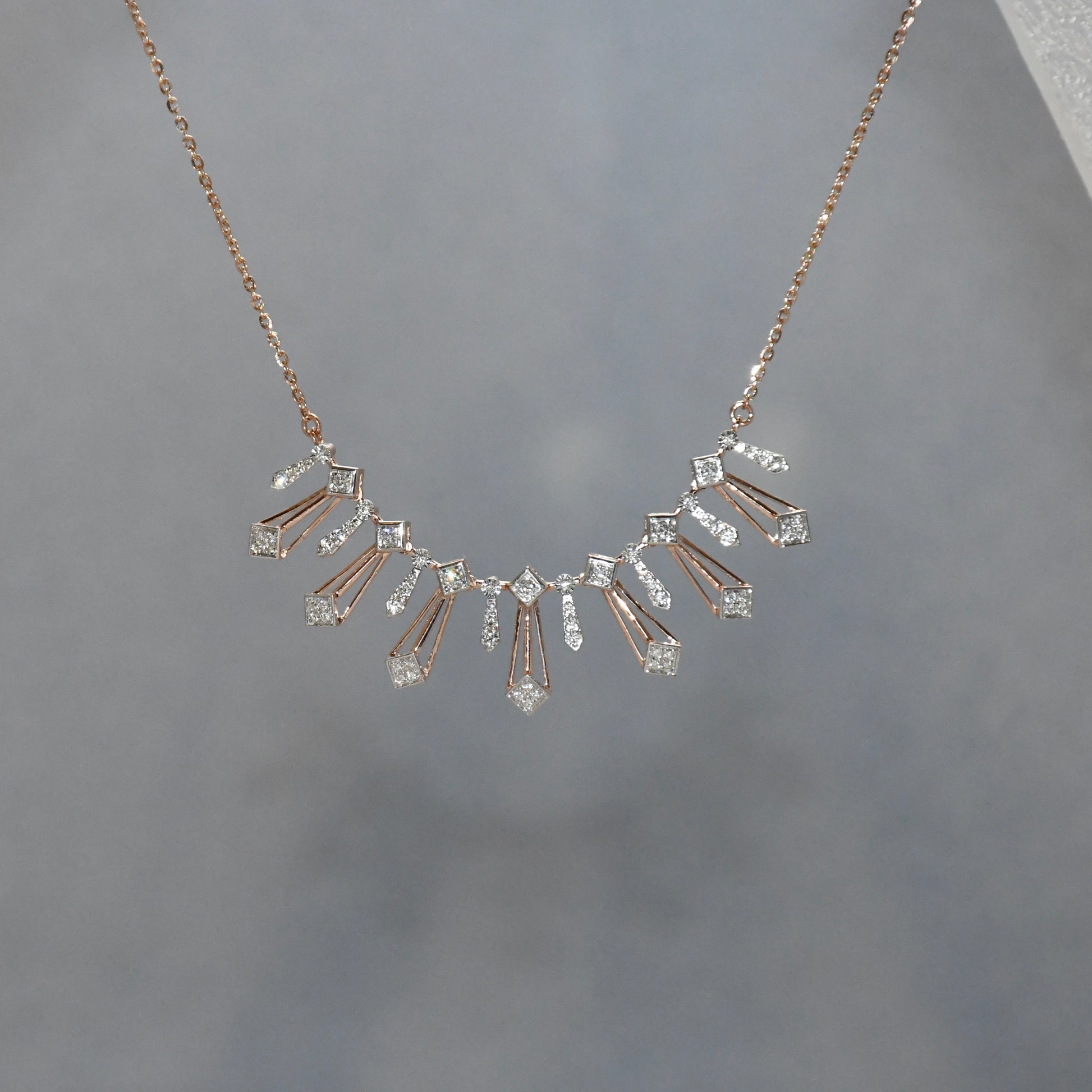 Delicate necklace with diamonds on a gray background