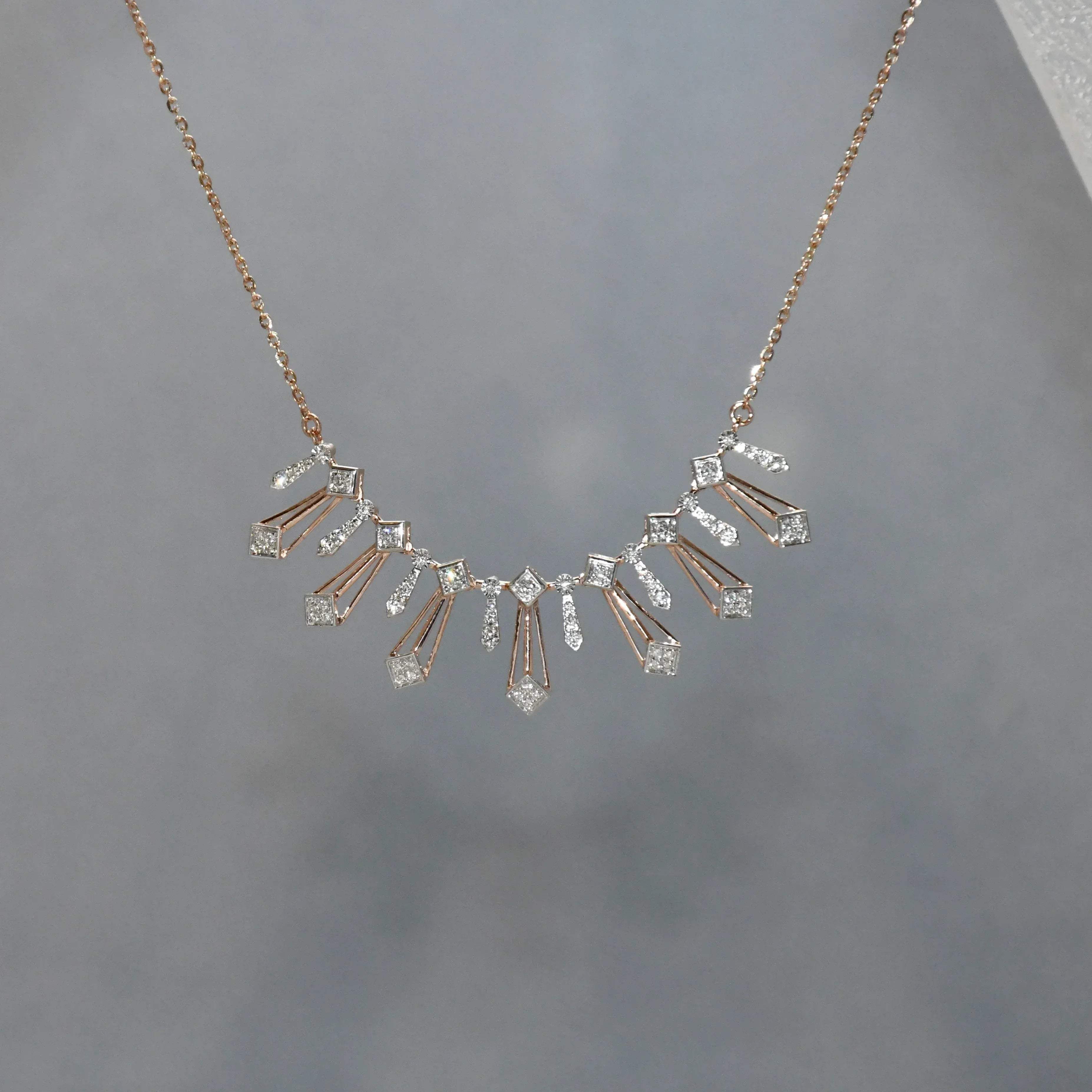 Delicate necklace with diamonds on a gray background