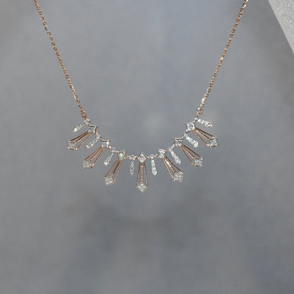 Delicate necklace with diamonds on a gray background