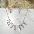 Diamond necklace and matching earrings on a marble surface