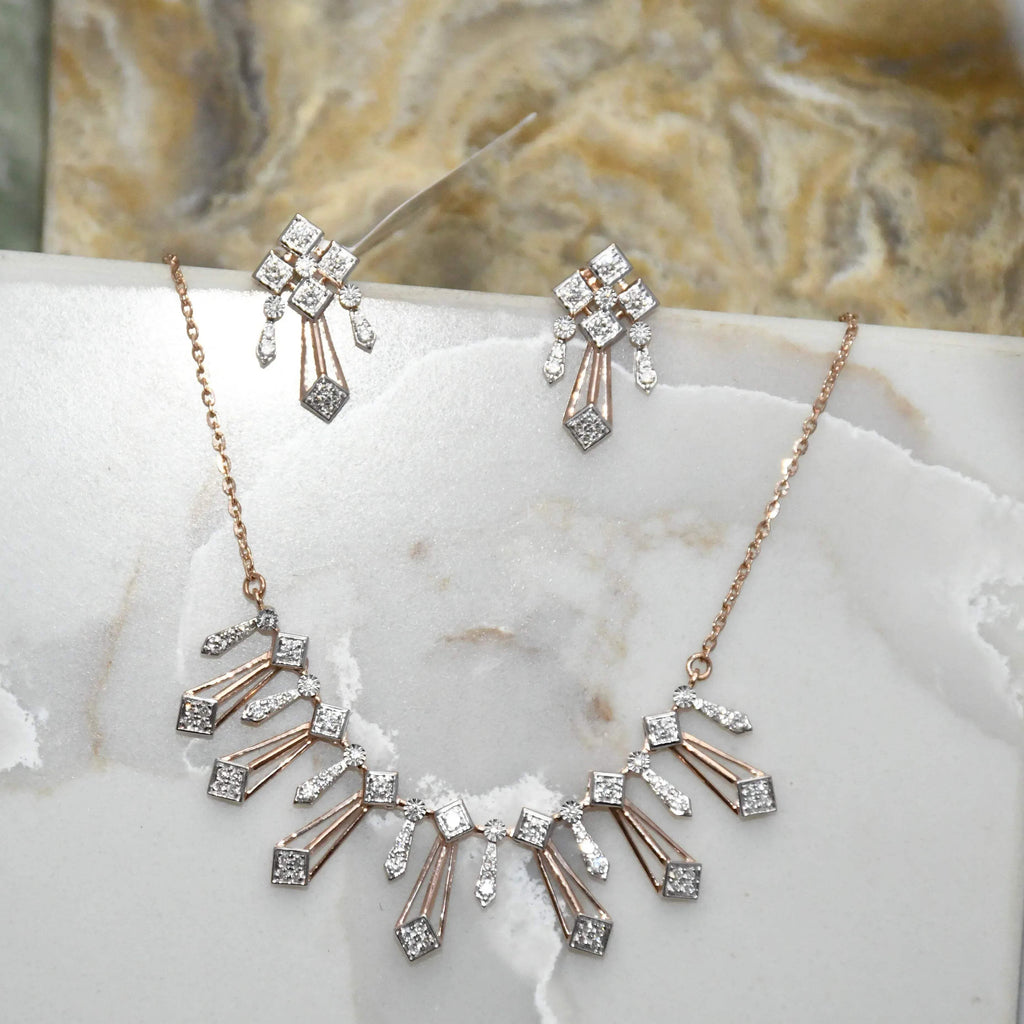 Diamond necklace and matching earrings on a marble surface
