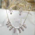 Diamond necklace and matching earrings on a marble surface