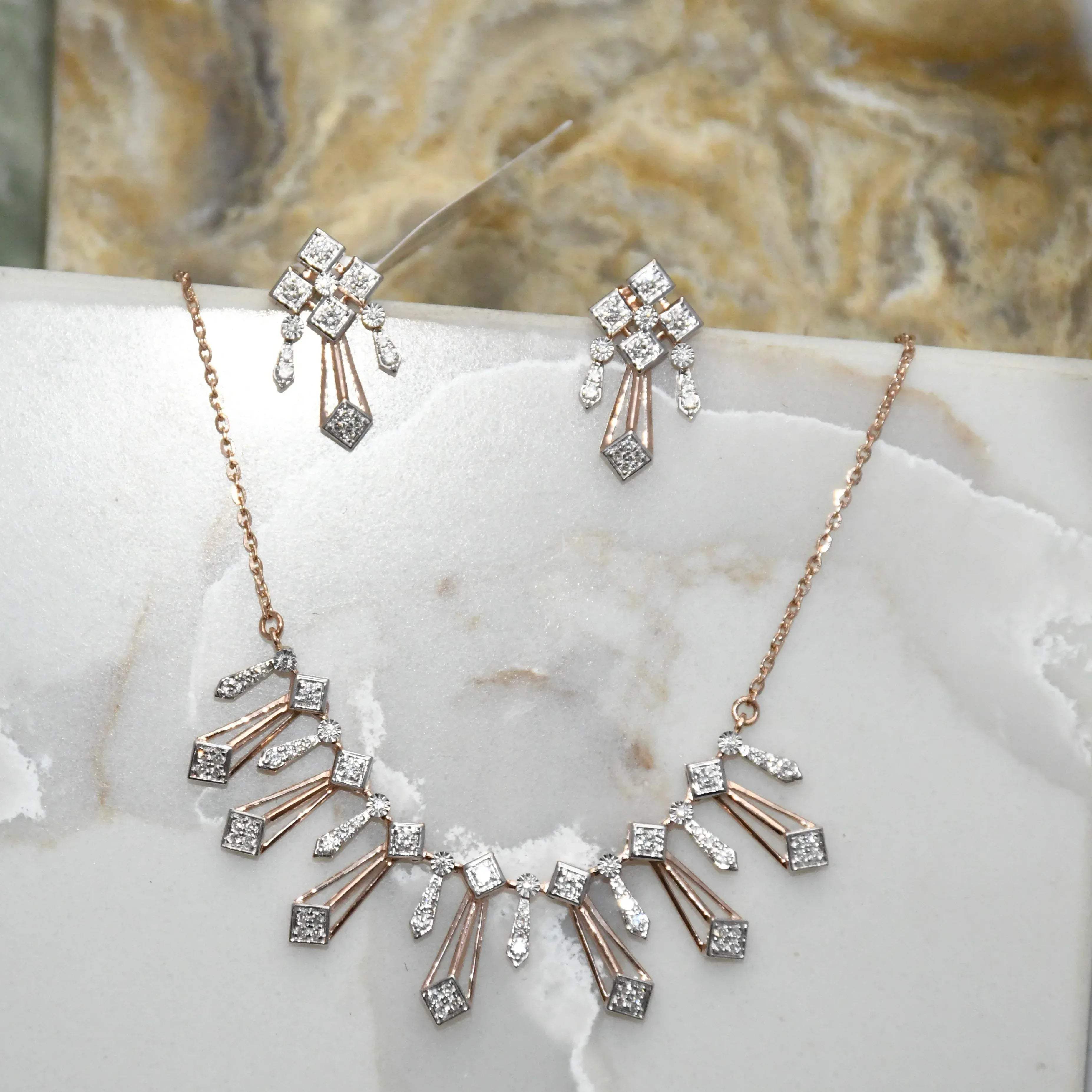 Diamond necklace and matching earrings on a marble surface