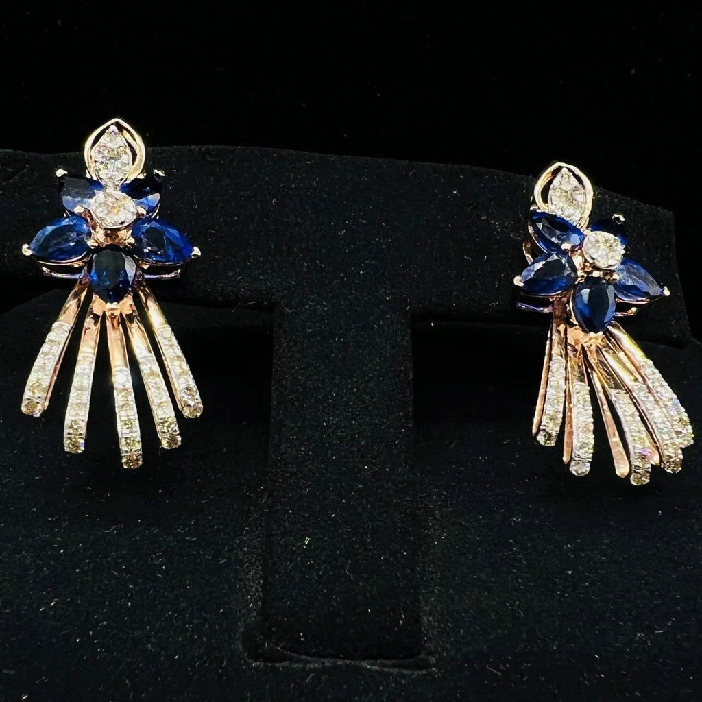 gold wedding earrings with round-cut blue color stones and clear diamonds displayed on a mannequin bust.