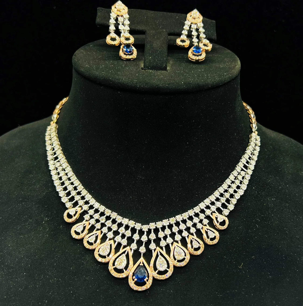 A gold bridal diamond necklace with round-cut beauty displayed on a mannequin bust.