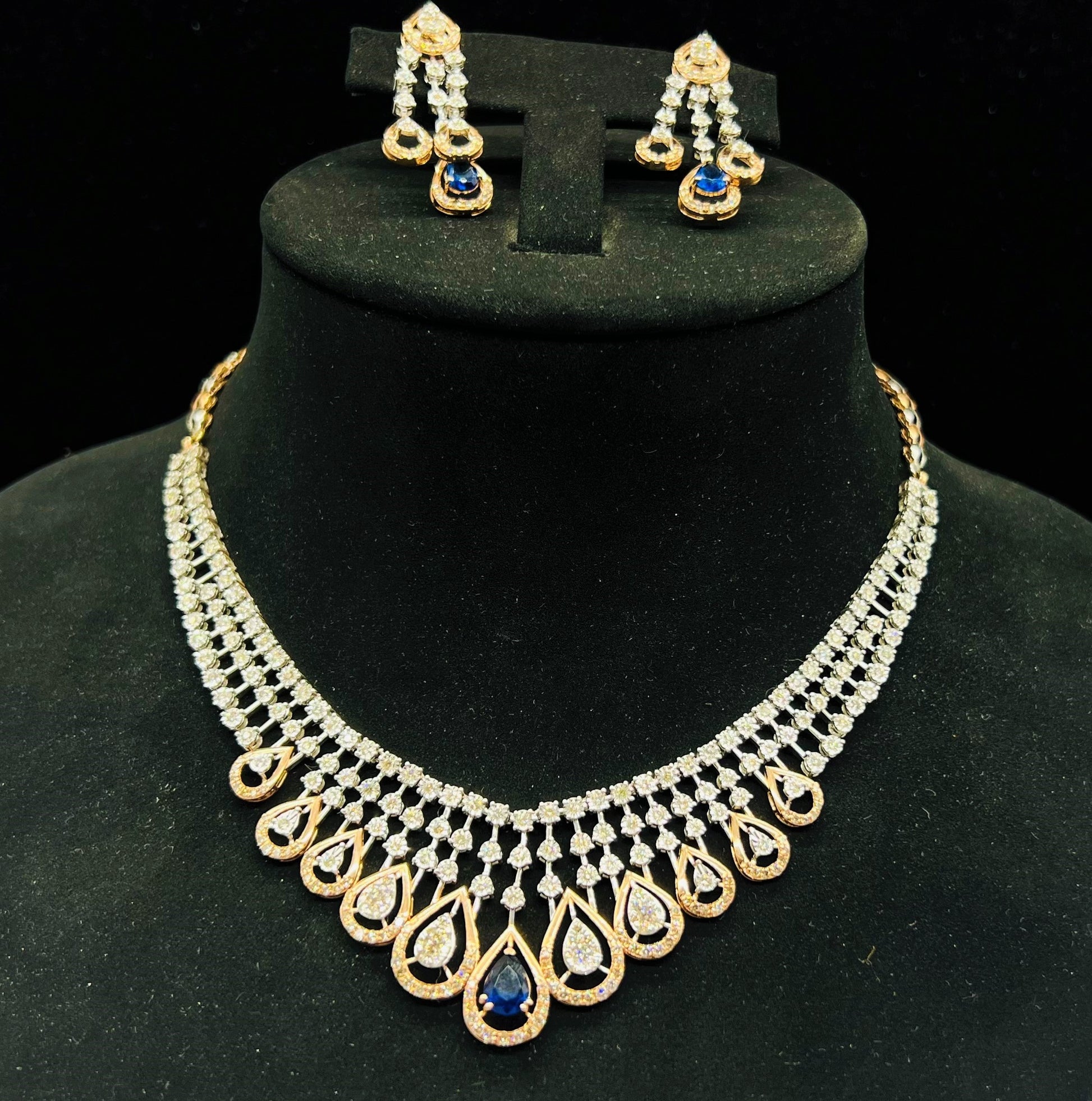 A gold bridal diamond necklace with round-cut beauty displayed on a mannequin bust.