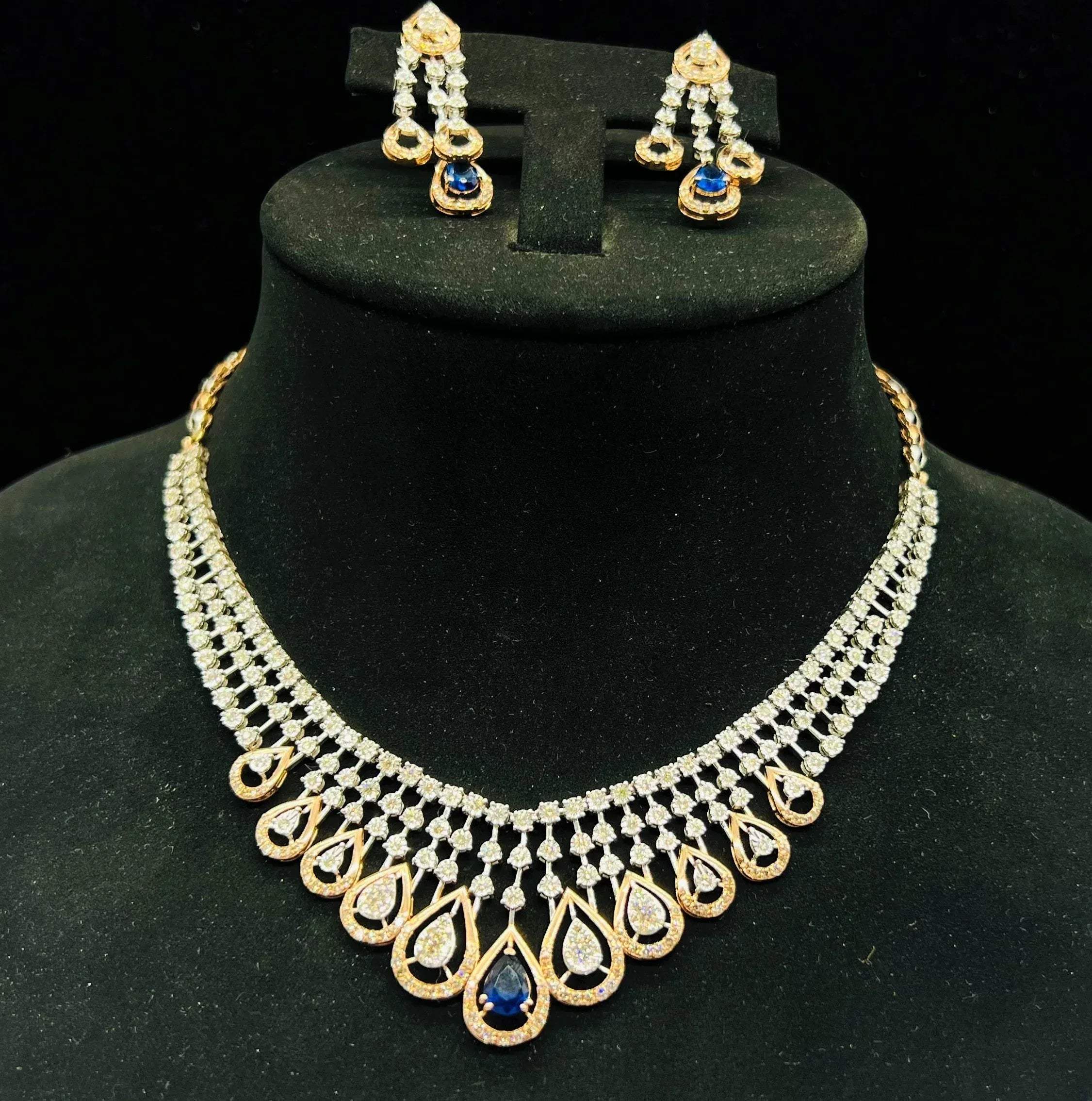 A gold bridal diamond necklace with round-cut beauty displayed on a mannequin bust.