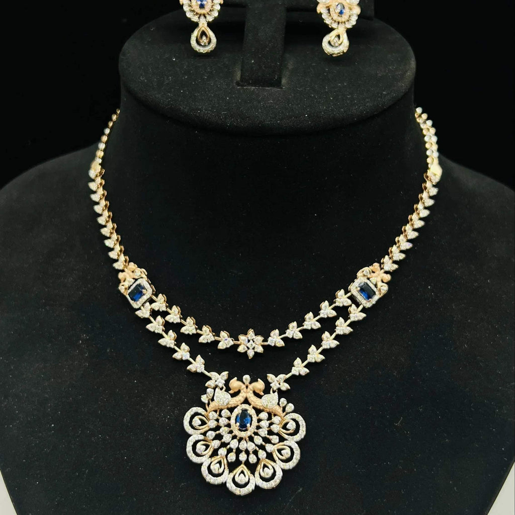 A gold diamond necklace with a floral pendant, displayed on a mannequin bust.