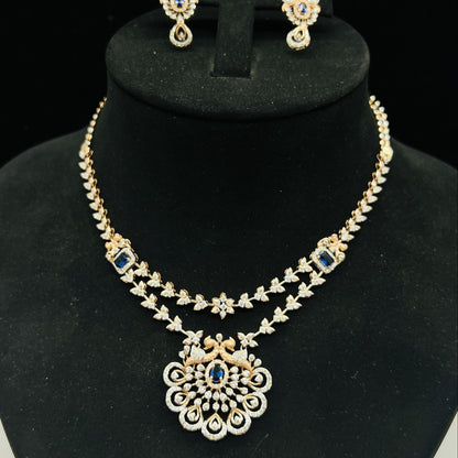 A gold diamond necklace with a floral pendant, displayed on a mannequin bust.