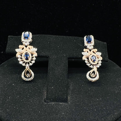 gold diamond earrings with a floral pendant, displayed on a mannequin bust.