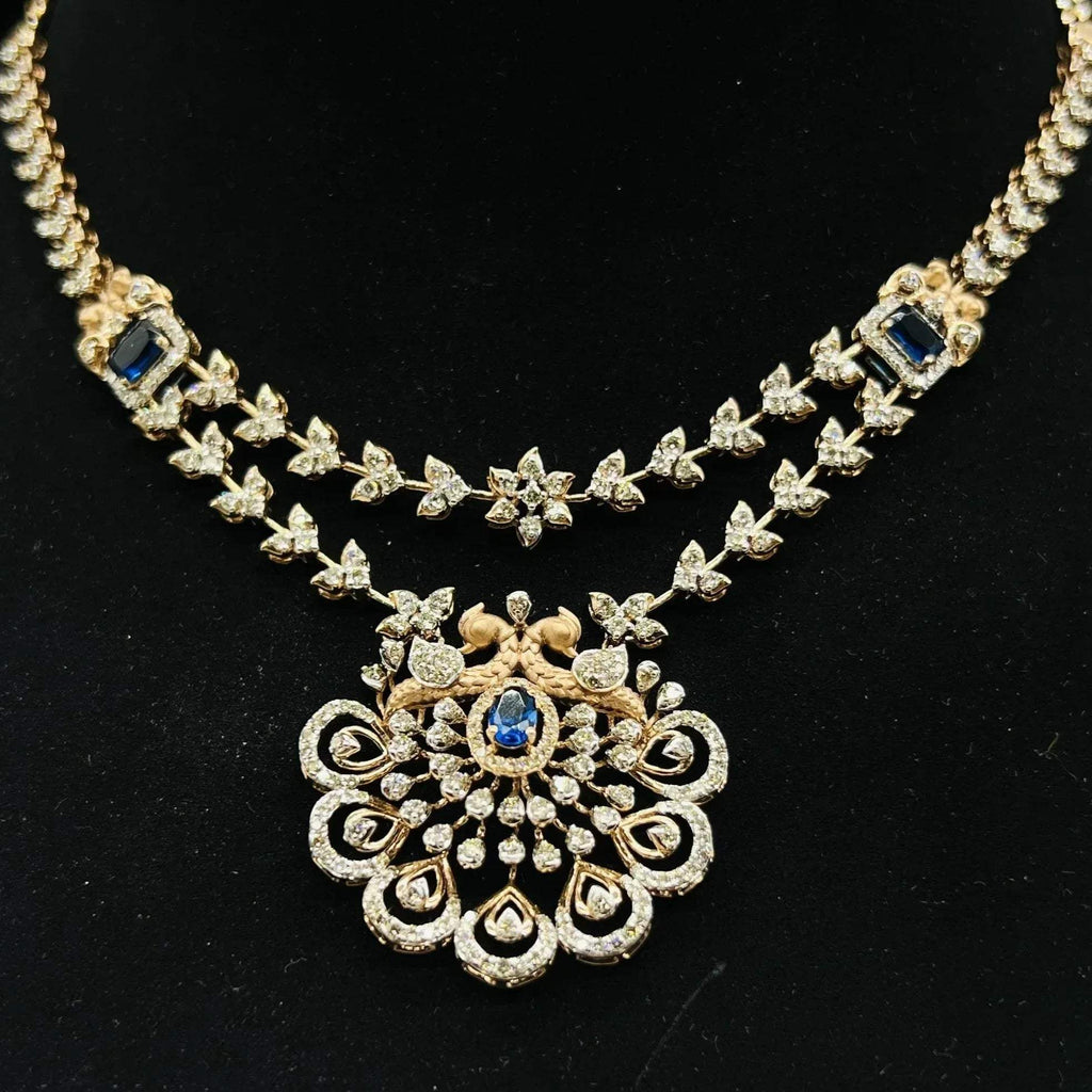 A gold diamond necklace with a floral pendant, displayed on a mannequin bust.