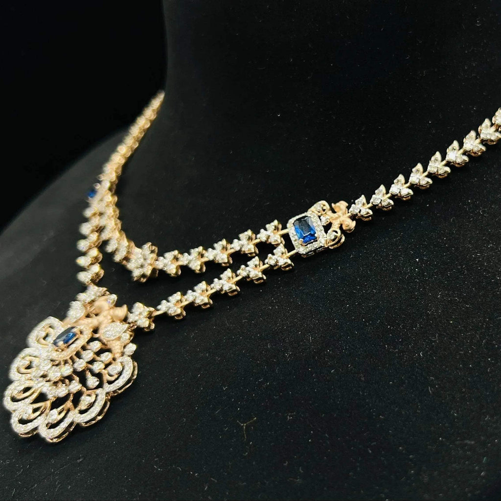 A gold diamond necklace with a floral pendant, displayed on a mannequin bust from left side.