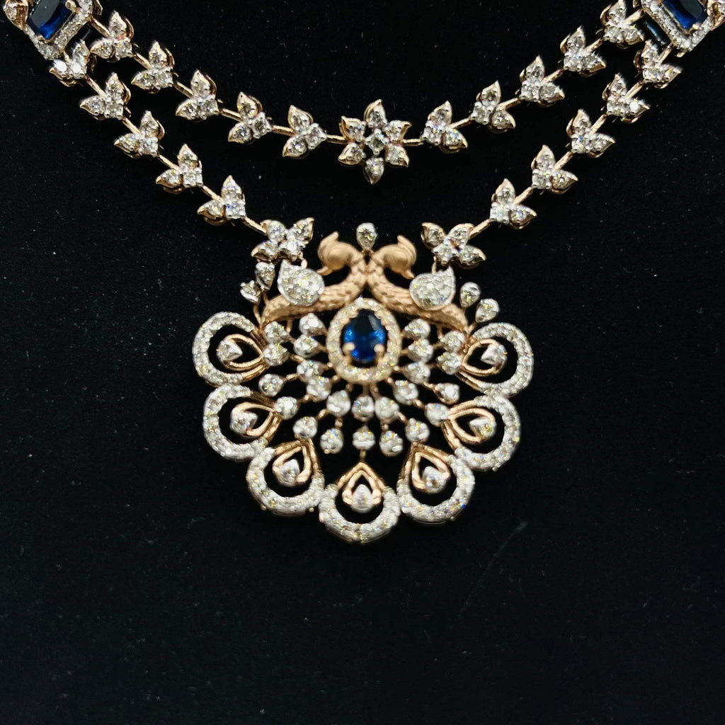 A gold diamond necklace with a floral pendant, displayed on a mannequin bust from front side.