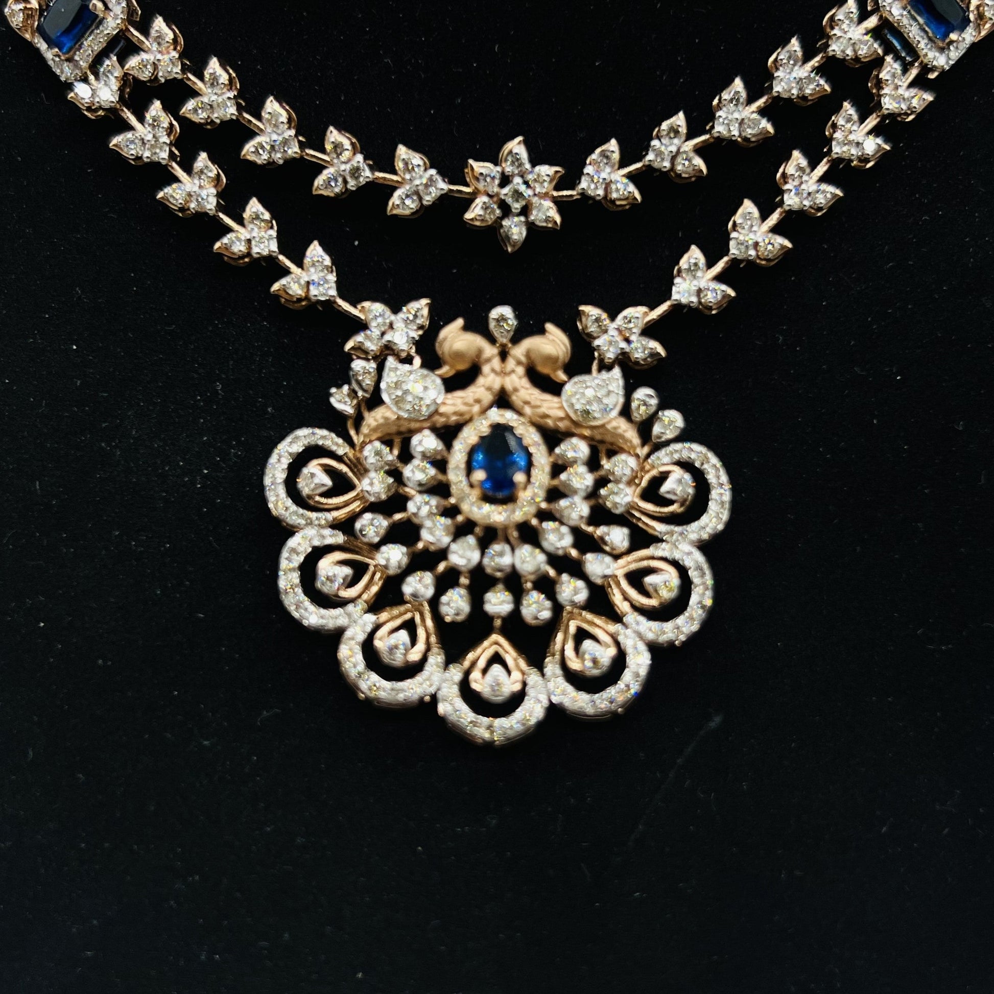 A gold diamond necklace with a floral pendant, displayed on a mannequin bust from front side.