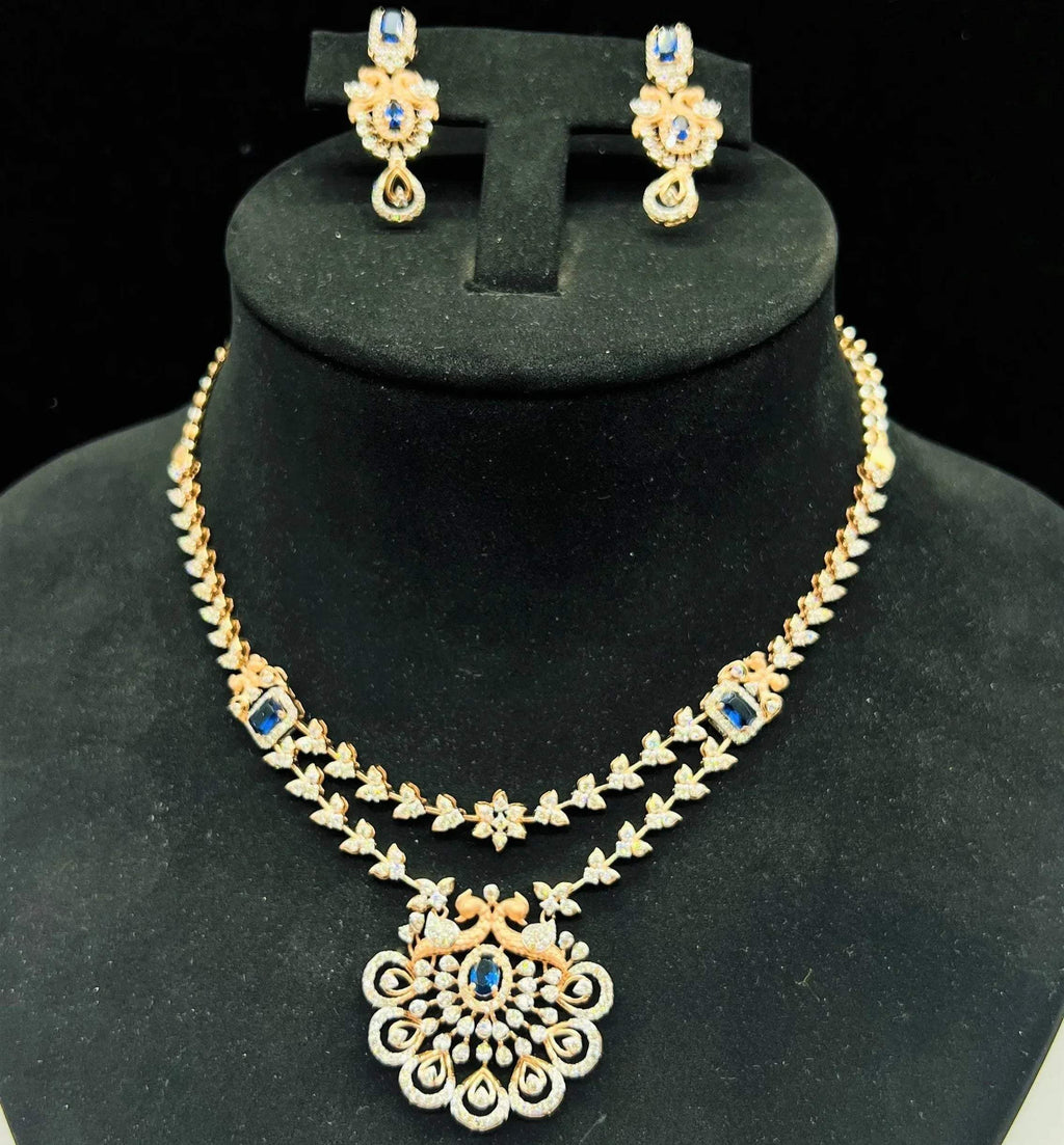 A gold diamond necklace with a floral pendant, displayed on a mannequin bust.