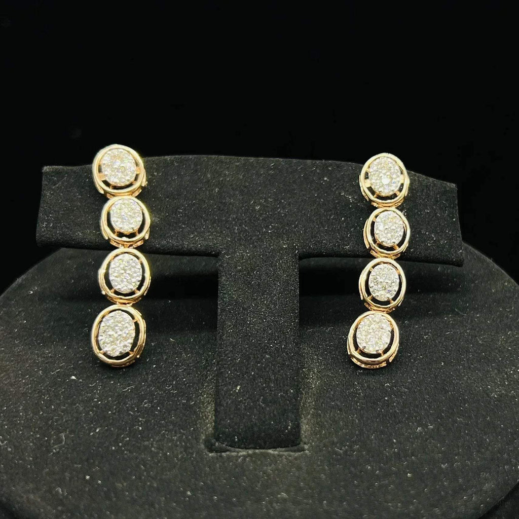 Gold diamond earrings set featuring oval-shaped, pavé-set diamonds in rose gold. The earrings has a linked design showcasing these sparkling stones evenly spaced. Earrings mirror the necklace stones in a vertical stack, creating an elegant accessory set on a black velvet background.