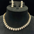 Gold diamond necklace set with matching earrings featuring oval-shaped, pavé-set diamonds in rose gold. The necklace has a linked design showcasing these sparkling stones evenly spaced. Earrings mirror the necklace stones in a vertical stack, creating an elegant accessory set on a black velvet background.