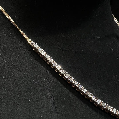 Designer diamond necklace set from side angle is displayed on a mannequin bust.