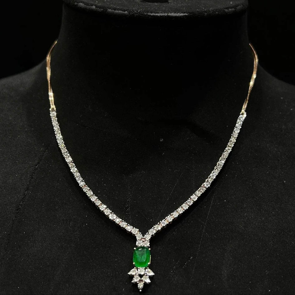 Designer diamond necklace set for women with color stone pendant and matching earrings.