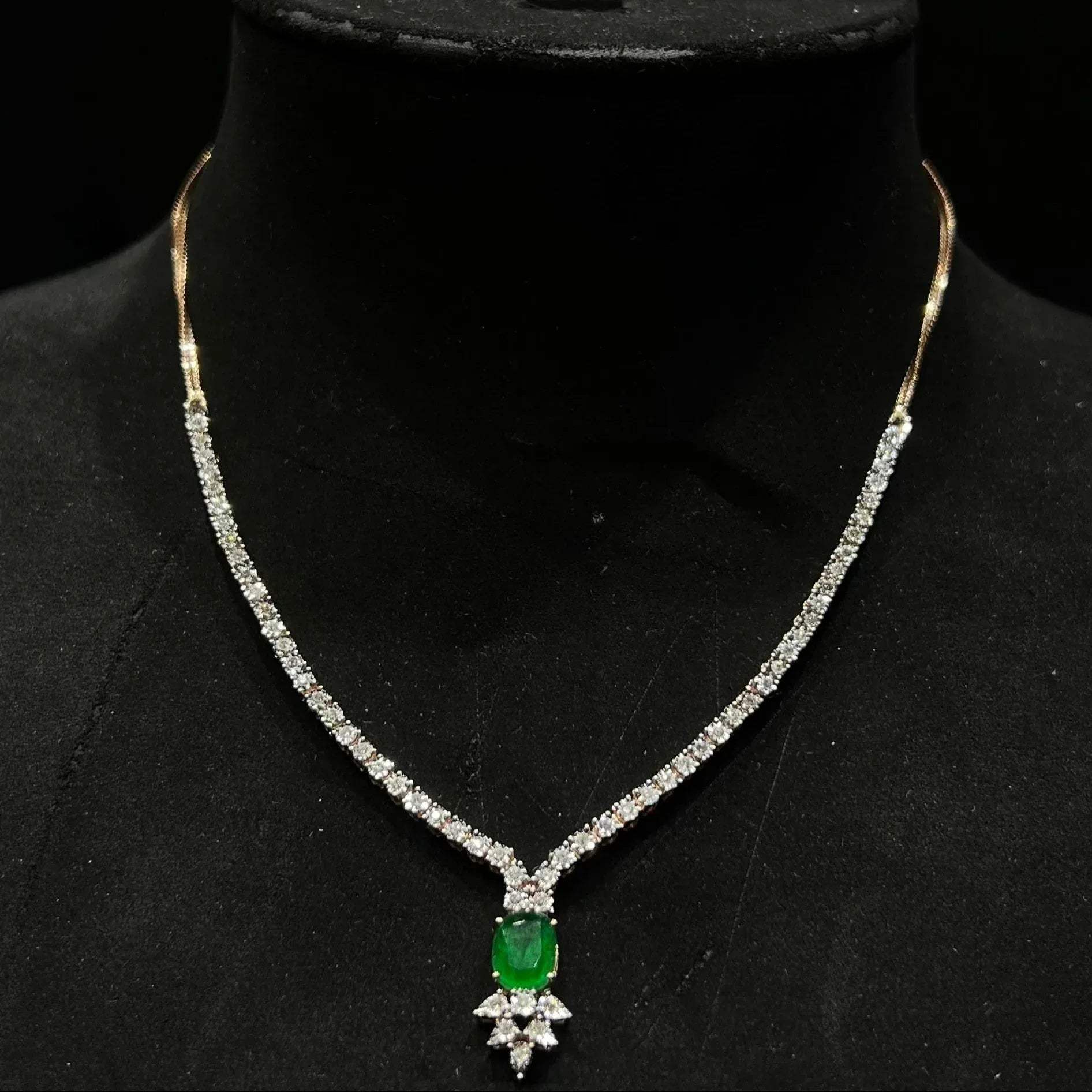 Designer diamond necklace set for women with color stone pendant and matching earrings.