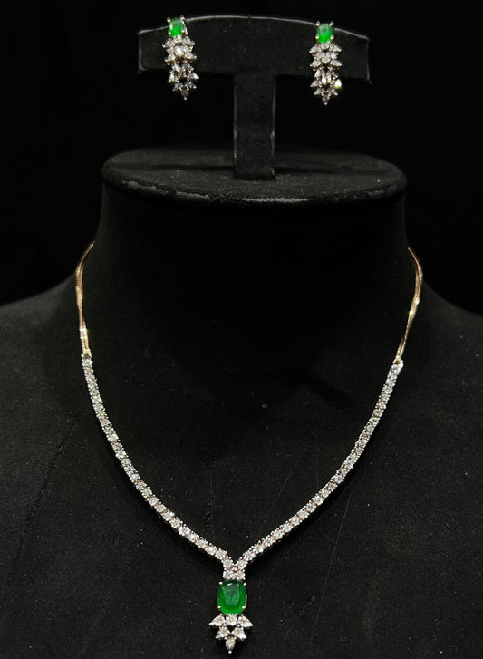 Designer diamond necklace set for women with color stone pendant and matching earrings.