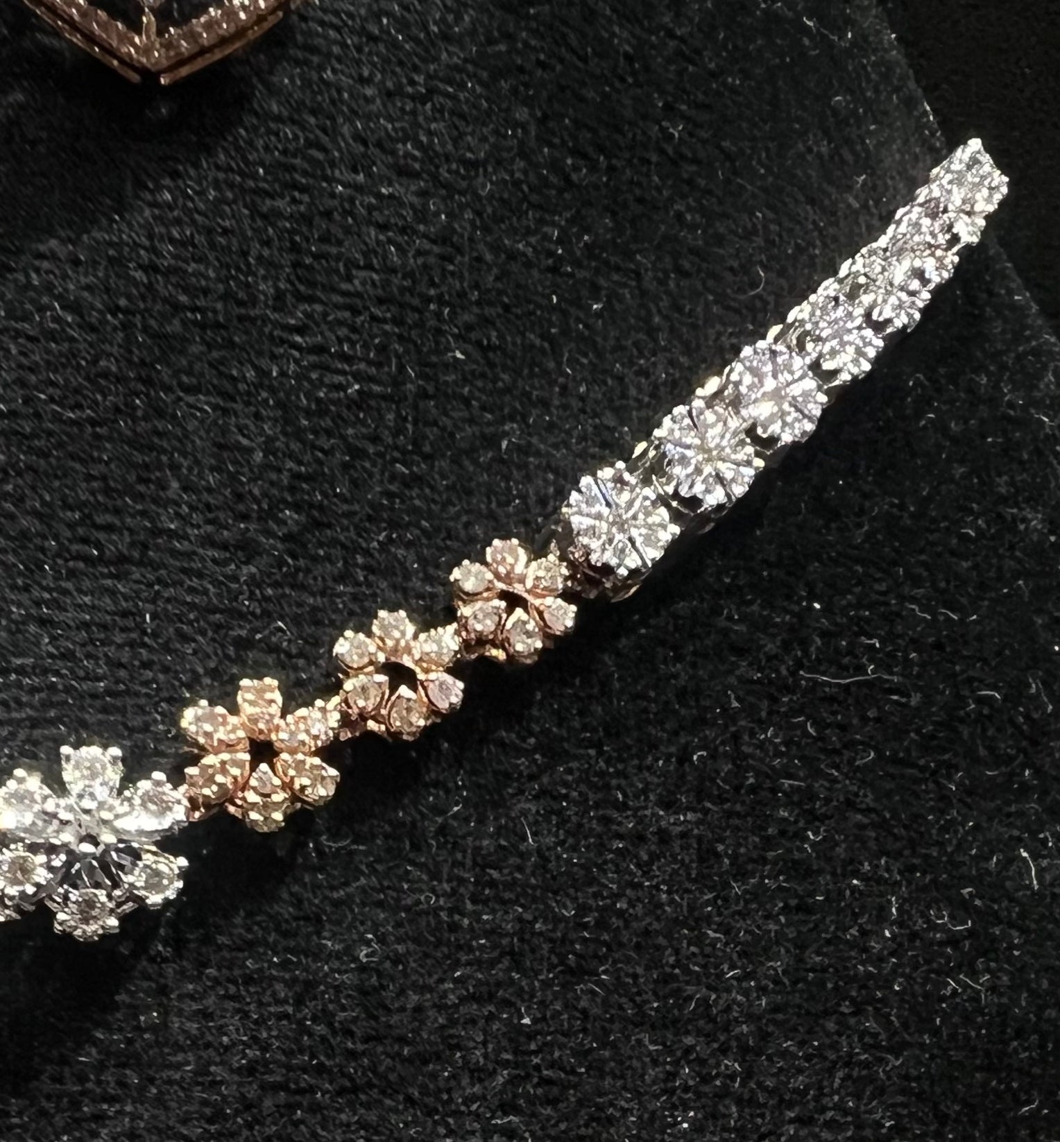 Floral design diamond necklace set with matching earrings, featuring a pear-shaped blue stone drop surrounded by natural diamonds.