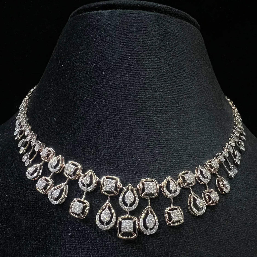 A 14K gold diamond necklace set displayed on a mannequin bust, featuring a solid gold structure with diamond encrusted in the necklace.
