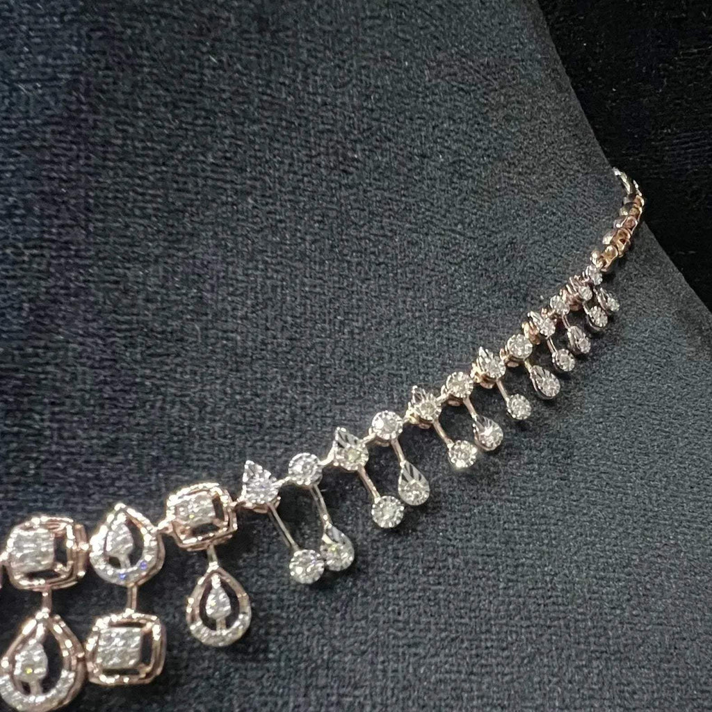 A gold diamond necklace is displayed on a mannequin bust.