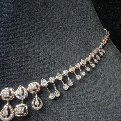 A gold diamond necklace is displayed on a mannequin bust.
