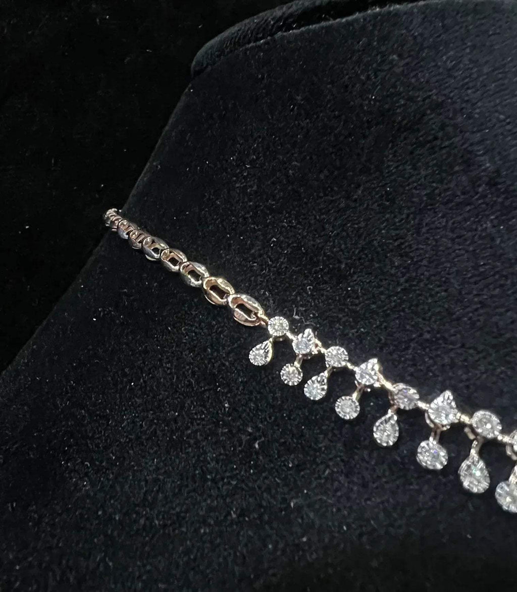 A diamond necklace displayed on a mannequin bust, featuring a solid gold structure with diamond encrusted in the necklace.