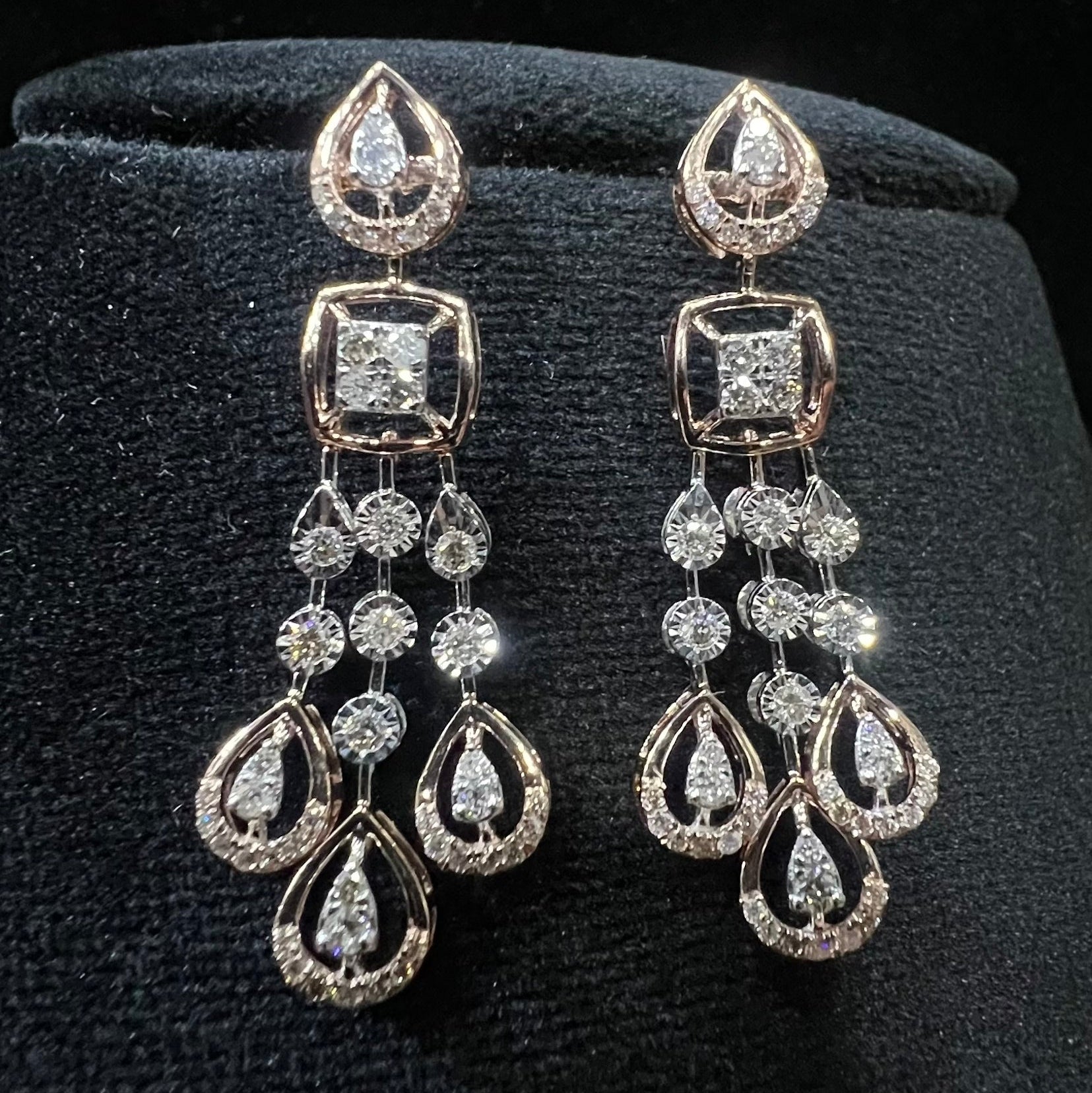 gold diamond earrings set displayed on a mannequin bust, featuring a solid gold structure with diamond encrusted in the earrings.