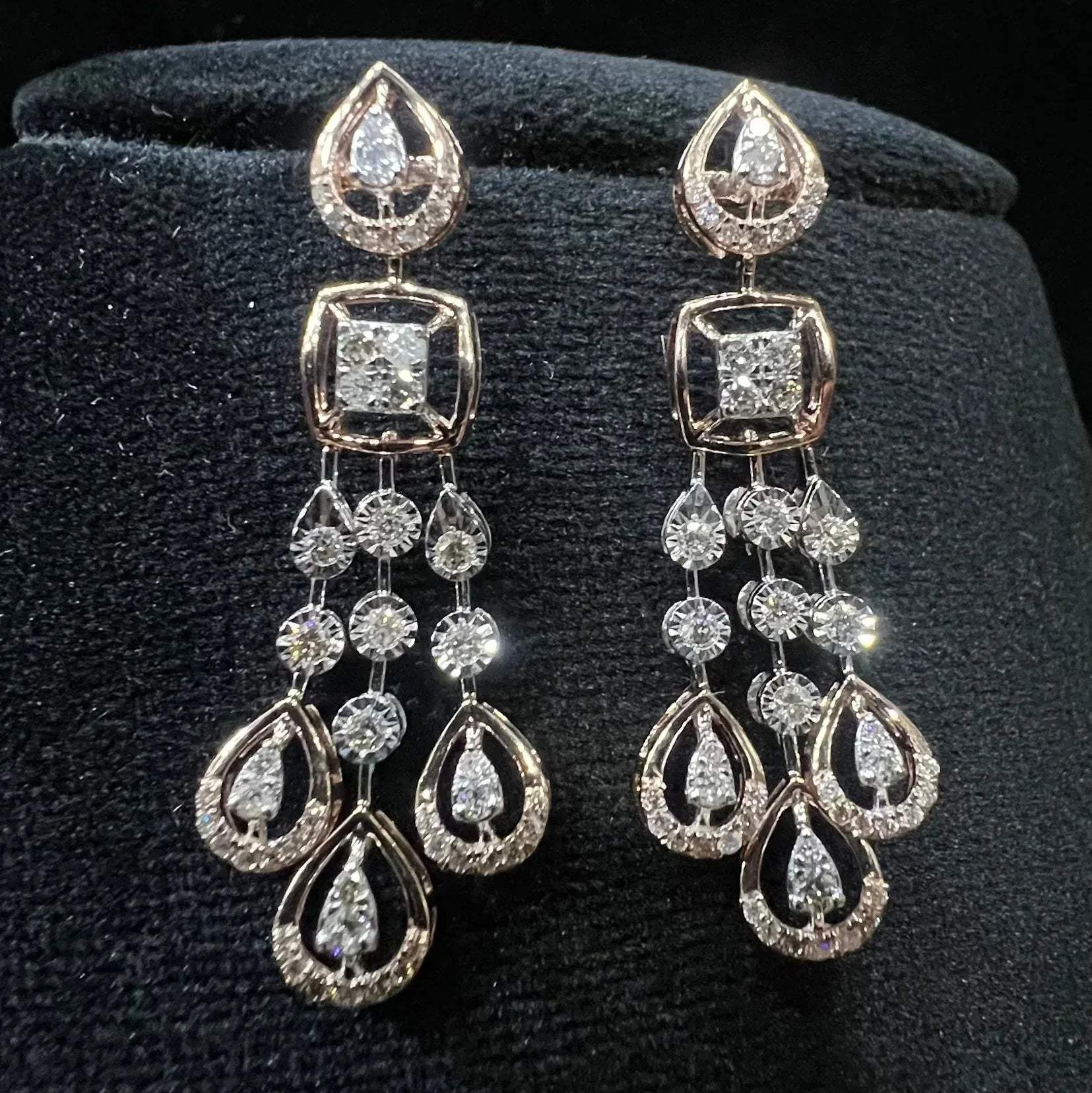 gold diamond earrings set displayed on a mannequin bust, featuring a solid gold structure with diamond encrusted in the earrings.