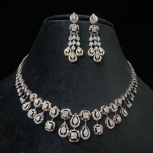 A gold diamond necklace and earrings set displayed on a mannequin bust, featuring a solid gold structure with diamond encrusted in the earrings and necklace.