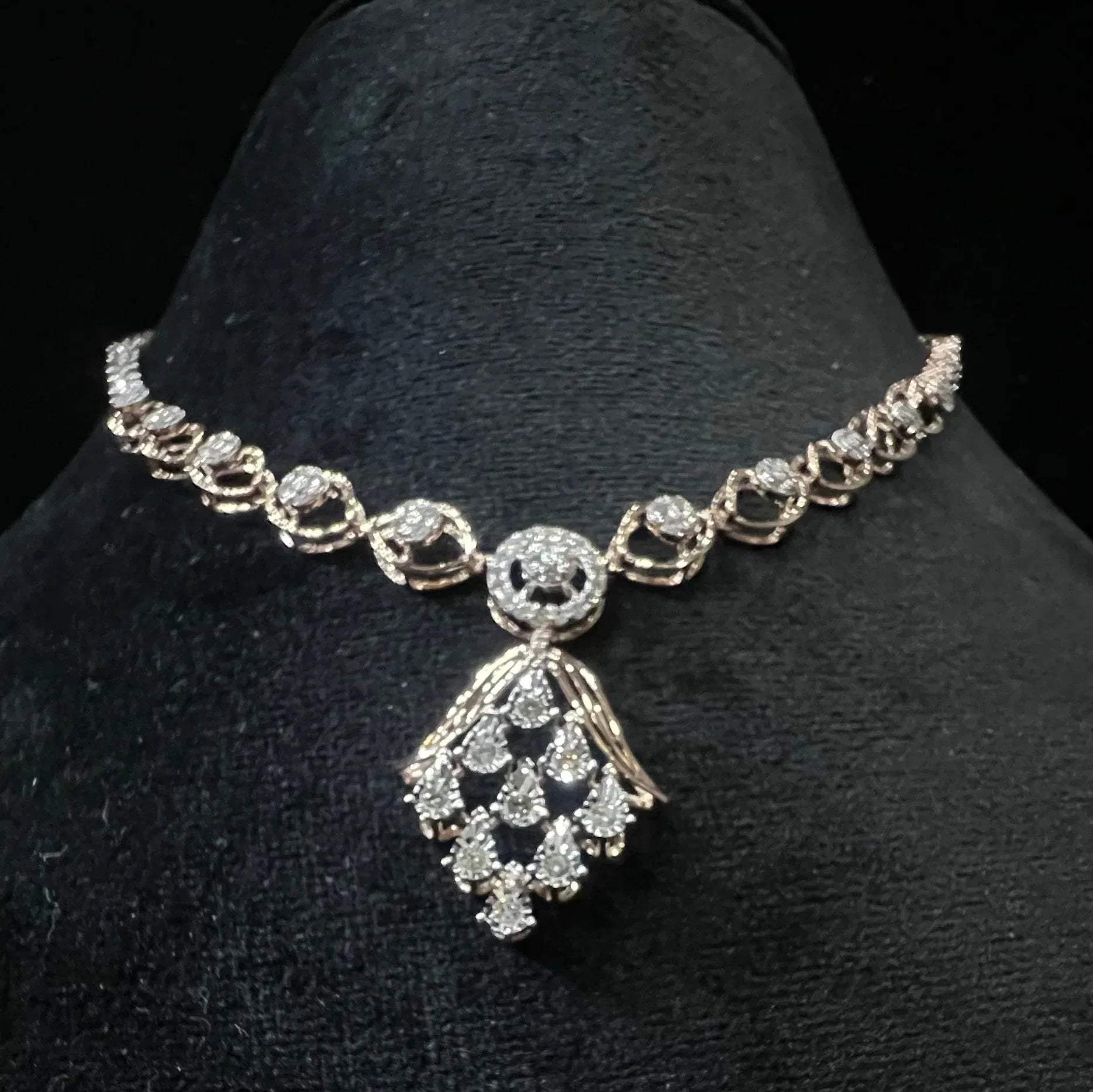 Radiant cascade diamond necklace set displayed on black velvet bust